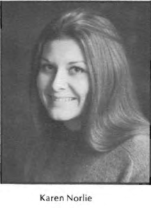 A black and white photo of a woman smiling.