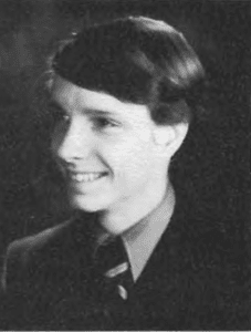 A young man in suit and tie smiling.