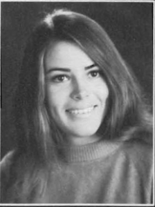 A young woman with long hair wearing a sweater.