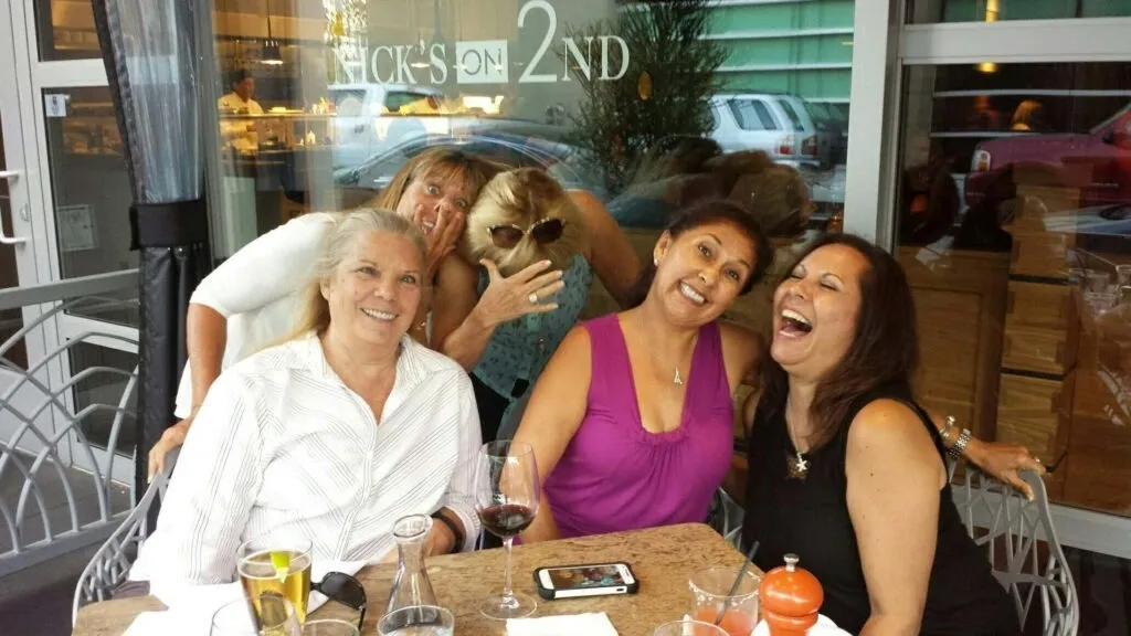 A group of women sitting at a table with drinks.