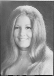 A young woman with long hair and a smile.